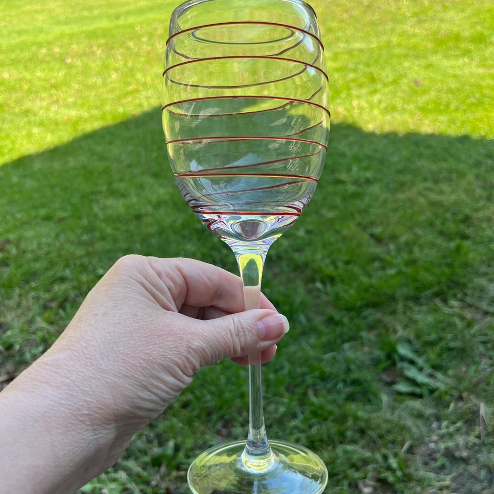 Pier 1 wine glass with red swirl design